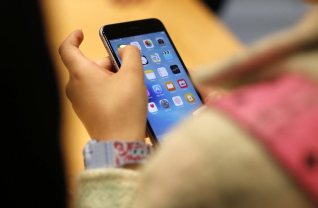 Screen Time Guidelines In this Sept. 25, 2015, file photo, a child holds an Apple iPhone 6S at an Apple store on Chicago's Magnificent Mile in Chicago. The World Health Organization Wednesday, April 24, 2019, issued its first ever guidance for how much screen time children under 5 should get: not very much, and none at all for those under 1. (AP Photo/Kiichiro Sato, File) The Associated Press