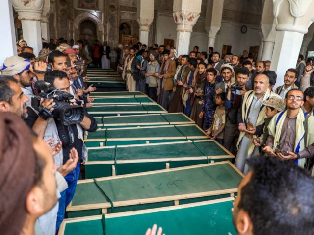 Yemeni mourners pray slogans by coffins at a mosque during a funeral in the Huthi-rebel-held capital Sanaa on March 14, 2019, for civilians killed in strikes in the northern Hajjah province. - The United Nations had confirmed that 22 civilians, including 12 children, were killed in strikes on March 9 …