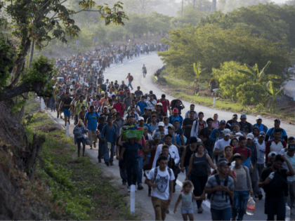 FILE - In this April 20, 2019, file photo, Central American migrants, part of a caravan hoping to reach the U.S. border, move on the road in Escuintla, Chiapas state, Mexico. The number of migrants apprehended at the Southern border topped 100,000 for the second month in a row, as …