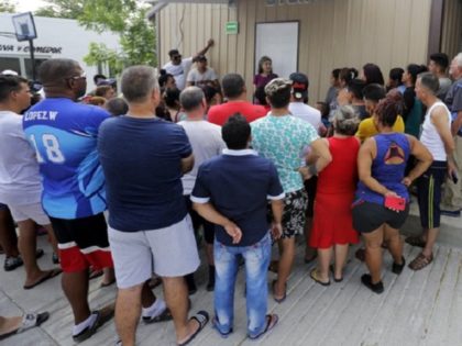 n this May 1, 2019, photo, human rights lawyer Jennifer Harbury, back center, speaks to as