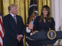 President Donald Trump looks to first lady Melania Trump as she speaks in the East Room of the White House in Washington, Wednesday, May 9, 2018, during an event celebrating military mothers and spouses. (AP Photo/Carolyn Kaster)