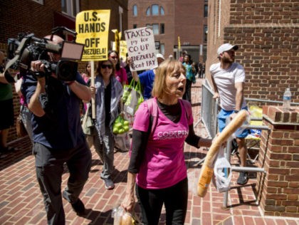 U.S. activist Medea Benjamin, co-founder of the anti-war group Code Pink, leads a group of pro Nicolas Maduro supporters to attempt to bring food and supplies into the Venezuelan Embassy in Washington, Thursday, May 2, 2019. Pro interim government opposition leader Juan Guaido supporters have blocked the entrances to the …