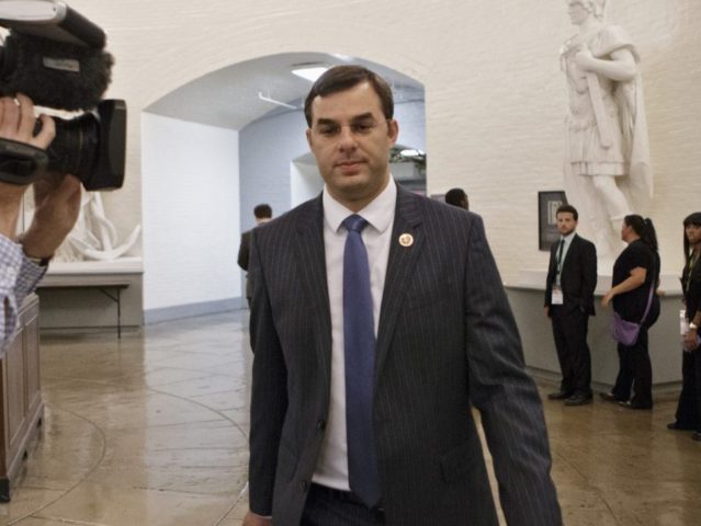 Rep. Justin Amash, R-Mich., walks through a basement corridor to the House of Representatives for the vote on his amendment to the Defense spending bill that would cut funding to the National Security Agency's phone surveillance program, on Capitol Hill, Wednesday, July 24, 2013. The White House and congressional backers …