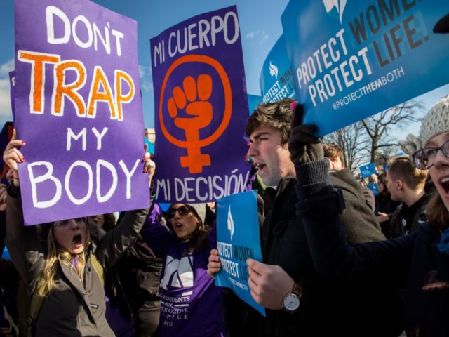 Pro-choice advocates (left) and anti-abortion advocates (right) rally outside of the Supreme Court, March 2, 2016 in Washington, DC. On Wednesday morning, the Supreme Court will hear oral arguments in the Whole Woman's Health v. Hellerstedt case, where the justices will consider a Texas law requiring that clinic doctors have …