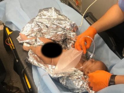A Honduran infant receives care from an emergency medical technician after nearly being drowned in the Rio Grande by a man claiming to be his father during an illegal border crossing. (Photo: U.S. Border Patrol/Del Rio Sector)