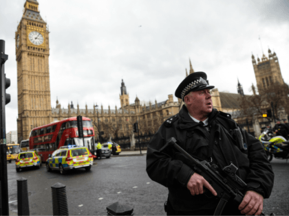 LONDON, ENGLAND - MARCH 22: An armed police officer stands guard near Westminster Bridge a