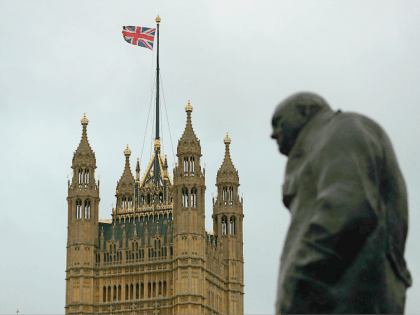 The Victoria tower of the Palace of Westminster that house the Houses of Parliament is seen next to a statue of Former British Prime Minister Winston Churchill in Westminster in central London on January 26, 2019. - Despite the humiliating rejection of Prime Minister Theresa May's Brexit deal, Britain is …