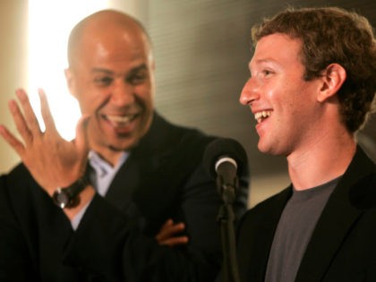 Newark Mayor Cory Booker, left, laughs as Mark Zuckerberg, right, founder and CEO of Faceb