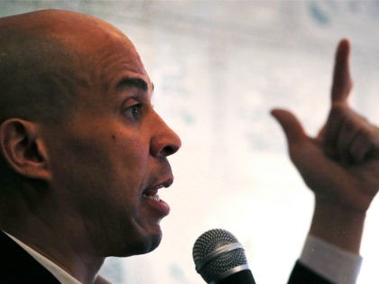 Democratic presidential candidate Sen. Cory Booker, D-N.J., gestures as he addresses guests at a house party during a campaign stop in Claremont, N.H., Friday, March 15, 2019. (AP Photo/Charles Krupa)