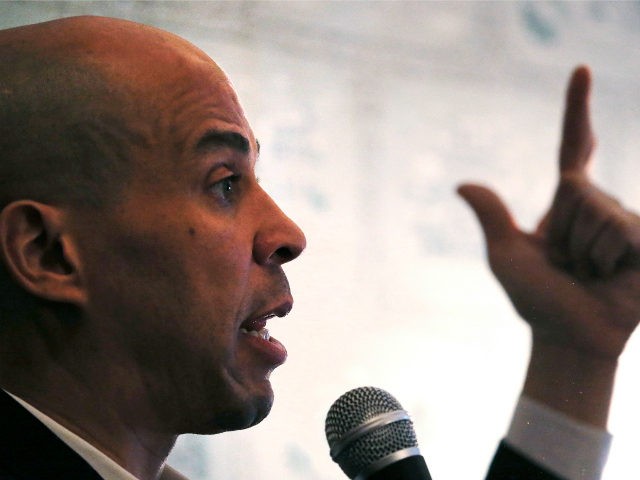 Democratic presidential candidate Sen. Cory Booker, D-N.J., gestures as he addresses guest