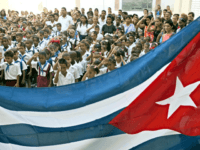 Cuban school children salute the national flag 03 September 2002 at the "Juramento de Baragua" elementary school in La Habana. This particular school was part of Fidel Castro's restoration project of 437 schools and construction of 344 schools to reach the standards of the National Education System. AFP PHOTO/Adalberto ROQUE …