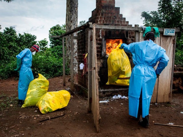 Health workers burn medical waste generated during care of patients with Ebola virus, on A