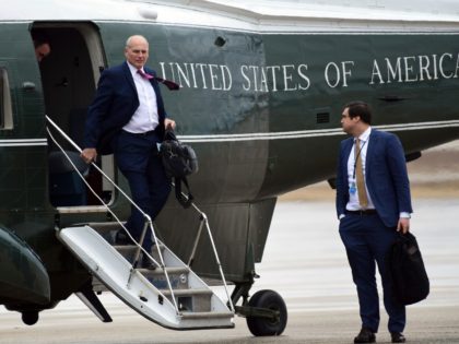 White House Chief of Staff John Kelly, left, walks off of Marine One as White House person