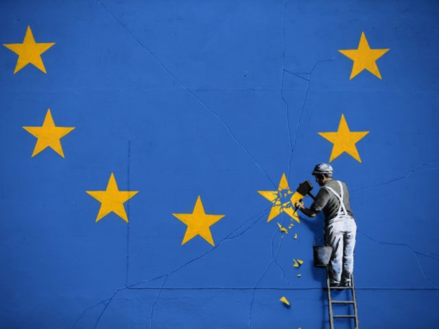 E.U. A recently painted mural by British graffiti artist Banksy, depicting a workman chipp