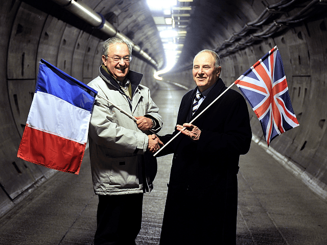 Former workers holding their national flags, French Philippe Cozette (L) and British Graha