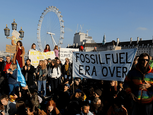 Demonstrators take part in a pro-environment protest as they block Westminster Bridge in c