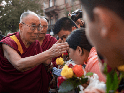 ibetan spiritual leader the Dalai Lama (L) greets wellwishers as he arrives on September 20, 2018 in Heidelberg, western Germany. - The Dalai Lama is attending the International Science Festival where he is to give a speech on "Happiness and Responsibility". (Photo by Marijan Murat / dpa / AFP) / …