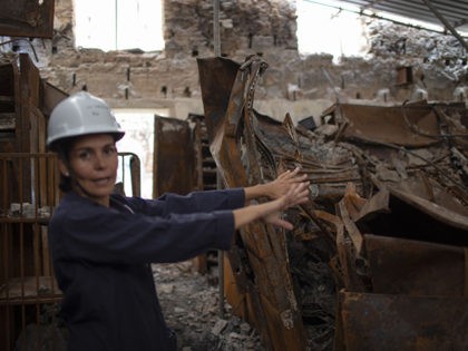 A worker talks to journalists during their first visit to Brazil's National Museum since the building burnt down last September, in Rio de Janeiro, Brazil, on February 12, 2019. - Brazil's historic National Museum was gutted by fire last year. The 200-year-old institution was considered the main natural history museum …
