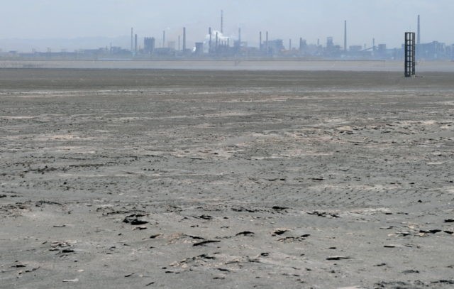 A vast expanse of toxic waste fills the tailings dam on April 21, 2011, frequently whipped