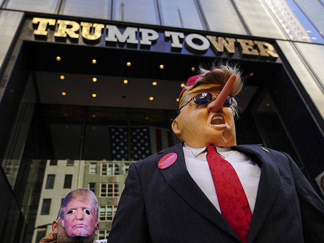 NEW YORK, NY - APRIL 1: Protestors wearing Donald Trump masks rally outside of Trump Tower
