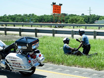 A police officers aids an officer involved in an accident while escorting a motorcade with US President Donald Trump from Chennault International Airport May 14, 2019, in Lake Charles, Louisiana. (Photo by Brendan Smialowski / AFP) (Photo credit should read BRENDAN SMIALOWSKI/AFP/Getty Images)