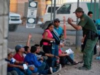 Migrants, mostly from Central America, wait to board a van which will take them to a processing center, on May 16, 2019, in El Paso, Texas. - About 1,100 migrants from Central America and other countries are crossing into the El Paso border sector each day. US Customs and Border …