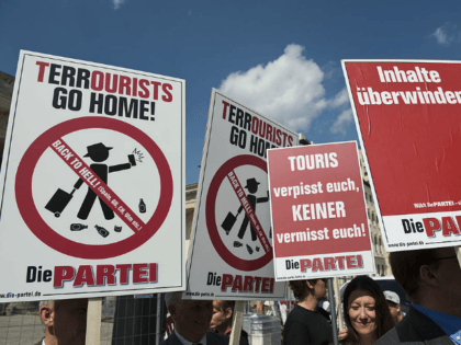Members of the satirical political party "Die Partei" display placards urging &q