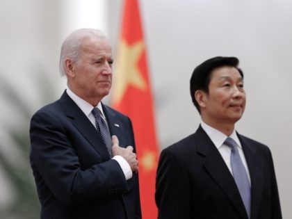 Chinese Vice President Li Yuanchao (R) and US Vice President Joe Biden (L) listen to their national anthems during a welcoming ceremony inside the Great Hall of the People in Beijing on December 4, 2013. Biden arrived in Beijing to raise concerns over a Chinese air zone ramping up regional …