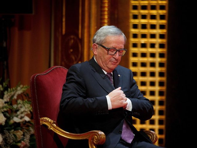 MADRID, SPAIN - OCTOBER 21: European Commission President Jean-Claude Juncker puts a pape