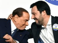 Leader of far-right party the League Matteo Salvini (R) embraces Head of the centre-right Forza Italia (Go Italy) Silvio Berlusconi during a joint press conference with leader of far-right party Brothers of Italy (unseen) at the Tempio di Adriano in Rome on March 1, 2018. Silvio Berlusconi's rightwing coalition, which …