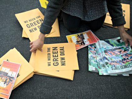 A volunteer prepares information packets for The Road to the Green New Deal Tour final event at Howard University in Washington, Monday, May 13, 2019. Presidential candidates Sen. Bernie Sanders, I-Vt., and Rep. Alexandra Ocasio-Cortez, D-N.Y., will address the rally. (AP Photo/Cliff Owen)