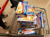 A customer heads to the checkout with a shopping cart loaded with Hostess snacks at a Jewel-Osco grocery store on December 11, 2012 in Chicago, Illinois. The Jewel-Osco grocery store chain purchased the last shipment of 20,000 boxes of Hostess products and put them on sale in their stores throughout …