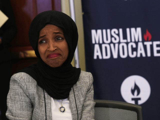 U.S. Rep. Ilhan Omar (D-MN) reacts as she listens to remarks during a congressional Iftar