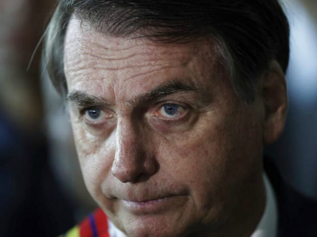 Brazil's President Jair Bolsonaro listens to a reporter's question at the end of a militar