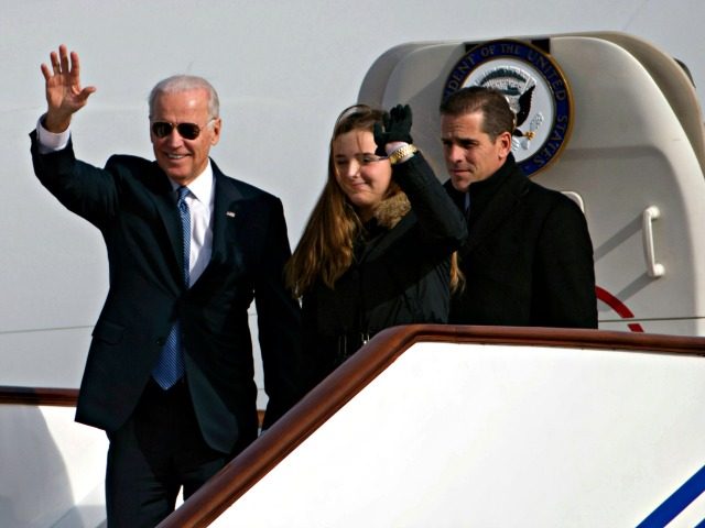 US Vice President Joe Biden waves as he walks out of Air Force Two with his granddaughter, Finnegan Biden (C) and son Hunter Biden (R) upon their arrival in Beijing on December 4, 2013. Biden arrived in Beijing on Decmber 4 amid rising friction over a Chinese air zone, needing …