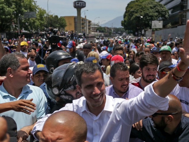 Venezuelan opposition leader Juan Guaido waves during a rally to commemorate May Day in Caracas on May 1, 2019. - Guaido called for a massive May Day protest to increase the pressure on President Nicolas Maduro. (Photo by CRISTIAN HERNANDEZ / AFP) (Photo credit should read CRISTIAN HERNANDEZ/AFP/Getty Images)