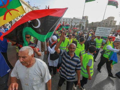 Libyans call for an end to fighting during a demonstration against strongman Khalifa Haftar in the capital Tripoli's Martyrs Square on May 3, 2019. - Haftar's forces in early April launched their assault on Tripoli, seat of the internationally-recognised Government of National Accord, pledging to clear the capital of "mercenaries …