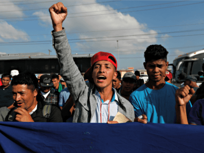 A Honduran migrant chants slogans during a demonstration outside the U.S. consulate in Tijuana, Mexico, Tuesday, Dec. 11, 2018. Migrants want U.S. authorities to speed up the asylum application process for members of migrant caravans seeking to enter the U.S., including accepting more applications per day. (AP Photo/Moises Castillo)