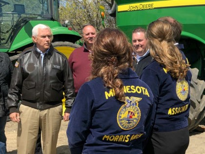 Vice President Mike Pence, left, visits with farmers and future farmers as he tours the R