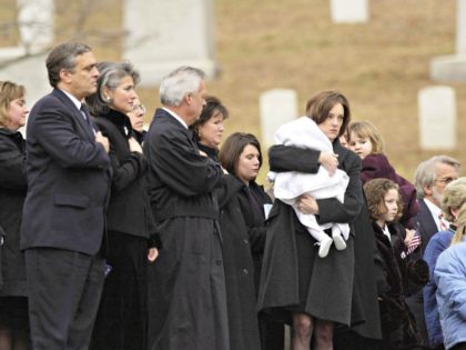Shannon Spann, carrying her infant son Jake, follows the coffin containing the body of her husband, CIA agent Johnny "Mike" Spann, during a full honors funeral December 10, 2001 at Arlington National Cemetery in Virginia. Spann, an agent of the Central Intelligence Agency who was killed during a prison uprising …