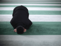 LONDON, ENGLAND - FEBRUARY 18: A Muslim man prays at Baitul Futuh Mosque in Morden on February 18, 2011 in London, England. Around five thousand Muslim men and women converged at the mosque today, which is Western Europe's largest, to Unite against Extremism and pay vigil following a series of …