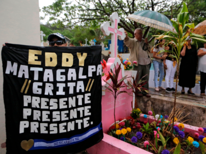 A sign reads "Eddy, Matagalpa shouts present, present, present" during the burial of Nicaraguan-US political prisoner Eddy Montes Praslin, killed in a riot in La Modelo maximum security prison, in Matagalpa, about 124 km southeast of Managua, on May 19, 2019. (Photo by INTI OCON / AFP) (Photo credit should …