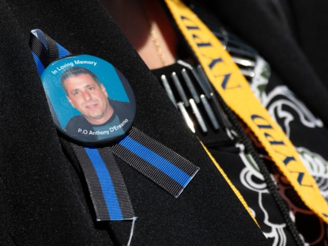A family member of New York Police Department Officer Anthony D'Erasmo, who died of cancer developed after participating in search and rescue efforts at the World Trade Center following the 9/11 attacks, wears a ribbon in his honor as she arrives to attend the 38th Annual National Peace Officers' Memorial …
