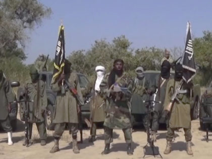 This Friday Oct. 31, 2014 image taken from video by Nigeria's Boko Haram terrorist network, the leader of Nigeria's Islamic extremist group Boko Haram, center, has denied agreeing to any cease-fire with the government and said Friday more than 200 kidnapped schoolgirls all have converted to Islam and been married …