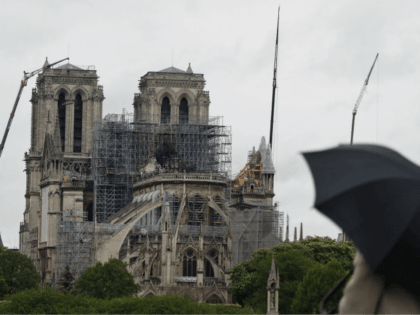 Cranes work at Notre Dame cathedral, in Paris, Thursday, April 25, 2019. French police scientists were starting to examine Notre Dame Cathedral on Thursday for the first time since last week's devastating fire. (AP Photo/Thibault Camus)