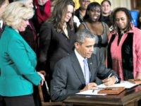 US President Barack Obama signs an executive order during an event in the East Room of the White House April 8, 2014 in Washington, DC. Brendan Smialowski/AFP/Getty