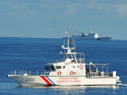 This photo taken on May 14, 2019, a Philippine coast guard ship (R) sails past a Chinese coastguard ship during an joint search and rescue exercise between Philippine and US coastguards near Scarborough shoal, in the South China Sea. - Two Philippine coastguard ships, BRP Batangas and Kalanggaman and US …