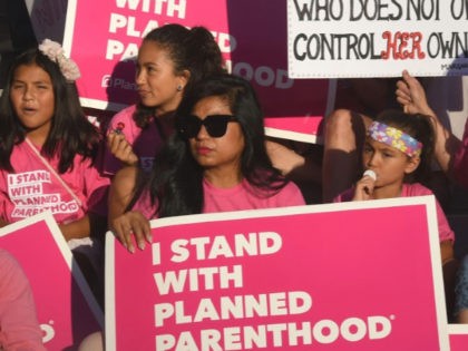 Supporters and patients of Planned Parenthood take part in a "Pink the Night Out" rally at