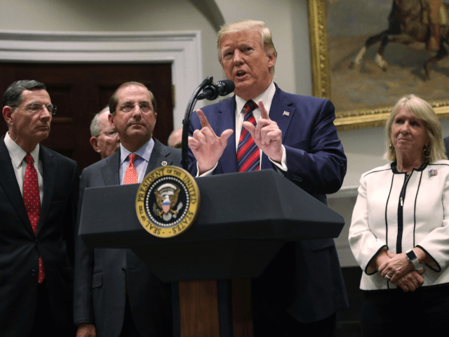 U.S. President Donald Trump speaks as Secretary of Health and Human Services Alex Azar (2nd L), Sen. John Barrasso (R-WY) (L) and Sen. Bill Cassidy (R-LA) (R) listen during a Roosevelt Room event at the White House May 9, 2019 in Washington, DC. The Trump administration is requiring drug manufacturers …