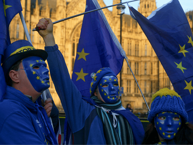 Pro-European Union, (EU), anti-Brexit demonstrators wear masks featuring the EU flag outside the Houses of Parliament in central London on December 18, 2017. / AFP PHOTO / Daniel LEAL-OLIVAS (Photo credit should read DANIEL LEAL-OLIVAS/AFP/Getty Images)